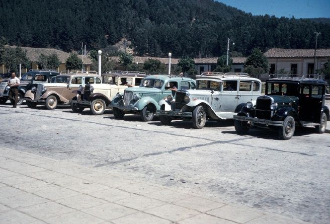 This photo is of the Taxi fleet at the train station in Constitucion at Christmas time, December, 1962.

The Elders of the Central District (Curico, Talca & Linares) were gathered here to celebrate Christmas.  This view is what greeted us as we deboarded the train.  And we used them to get to our hotel.
Andrew Milton Jensen
09 Feb 2013