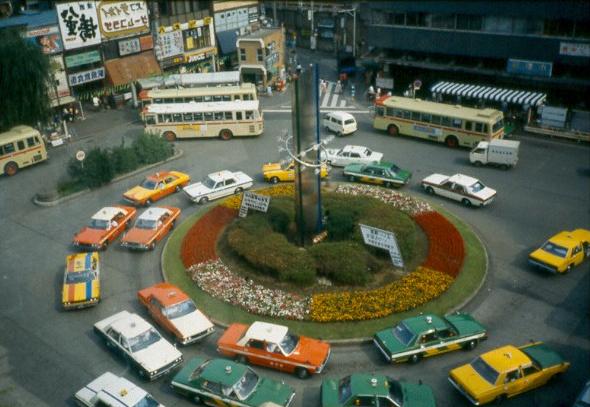 Taxi and buses waiting to pickup passengers in Tokyo.  Looking down from the Senkawa Building in Nerima-Ku where we were eating Curry Katsu at the Gyuyu Chain.
David  van der Leek
17 Aug 2003
