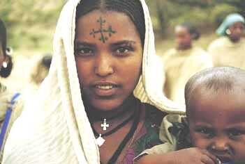 An Ethiopian woman with a tatoo of a cross on her head wearing her gabi.
Joshua M. Barlow
02 Jul 2001
